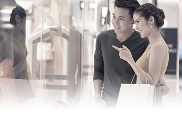 Couples are shopping and using an EastWest Card for payment.