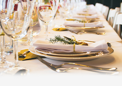 Table with wine glass, plate, spoon and fork
